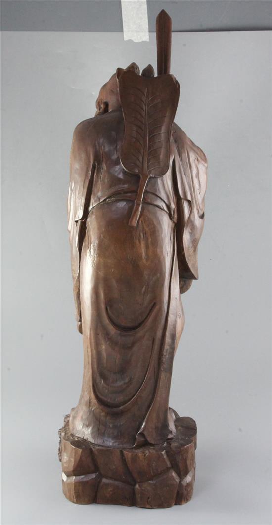 A large Chinese hardwood figure of Lu Dongbin, late 19th/early 20th century, height 71cm, replacement sword blade
